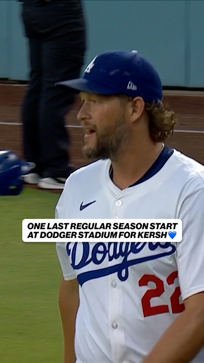 Dodger's Clayton Kershaw throws pitch into the grass