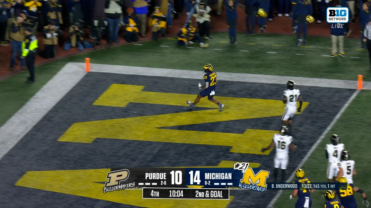 Jordan Marshall rushes 9 yards through the pile to extend Michigan’s lead over Purdue