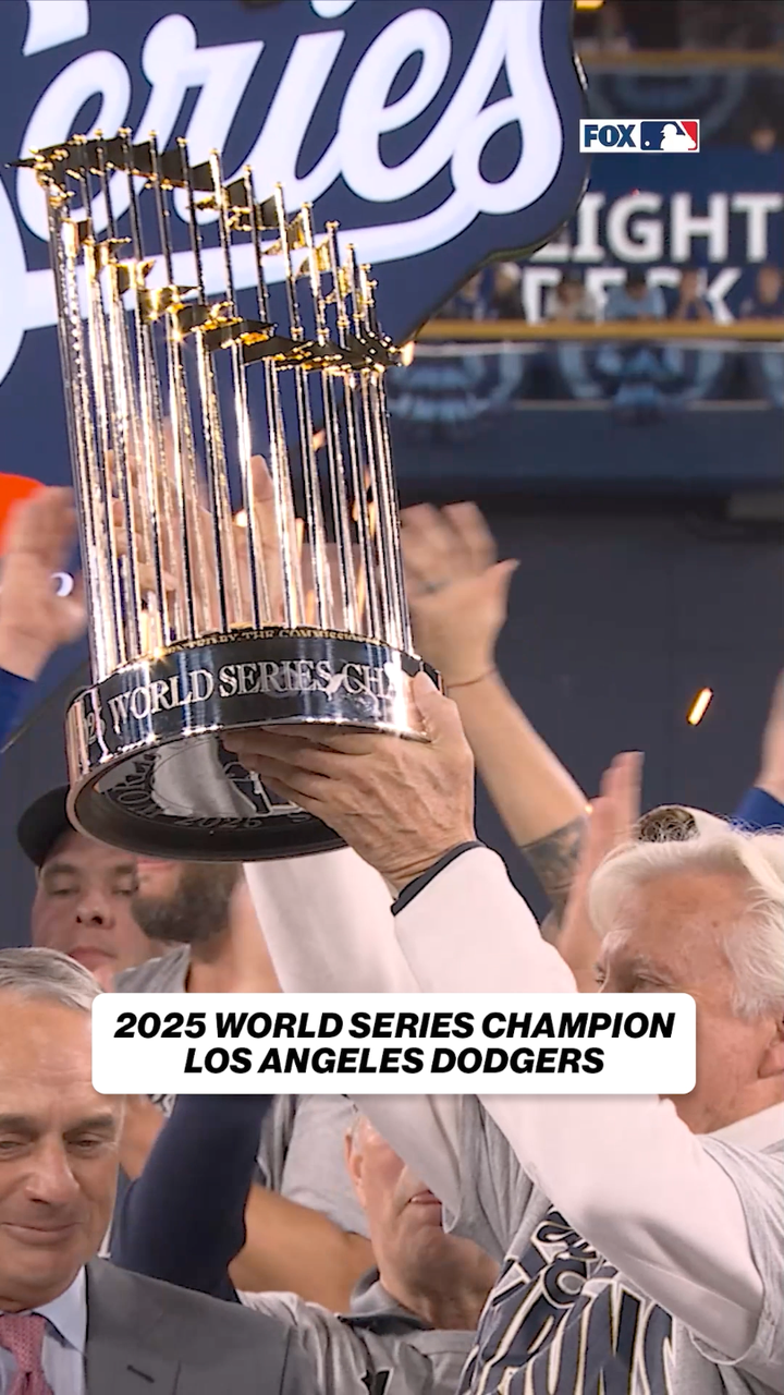 The Dodgers hoist the Commissioner's Trophy after winning 2025