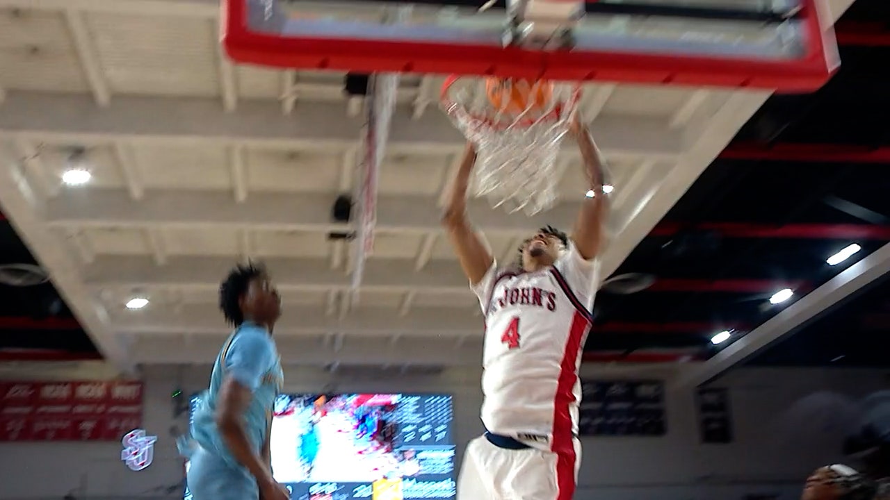 Oziyah Sellers drives through two defenders for a dunk, extending St. Johns lead over Quinnipiac