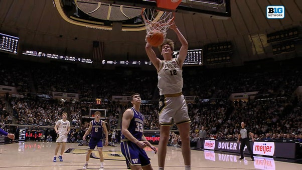 Braden Smith sets up Daniel Jacobsen for an alley-oop dunk, extending Purdue's lead over Washington 