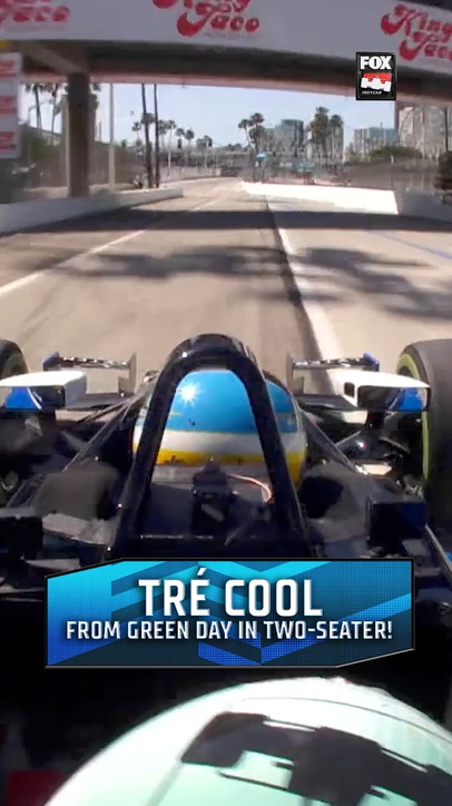 It's Green Day's Tré Cool in the two-seater! 🥁