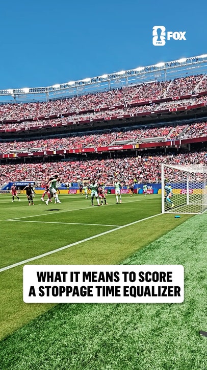 Pitchside angle of Qatar securing its first-ever FIFA World Cup point