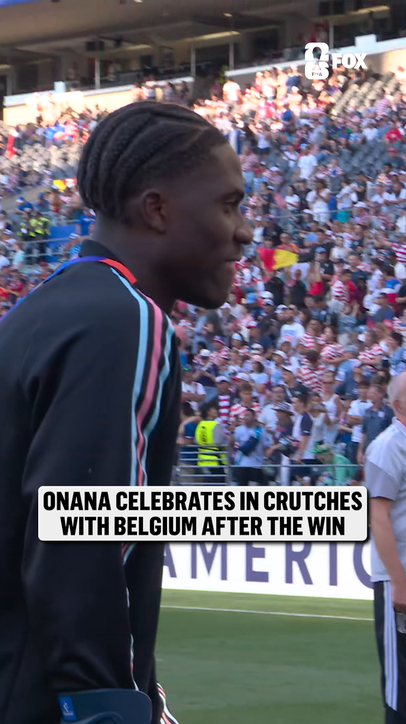 Belgium's Amadou Onana celebrates with his team after suffering from an injury earlier in the match