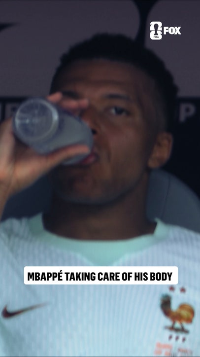 Mbappé icing his right ankle on the bench