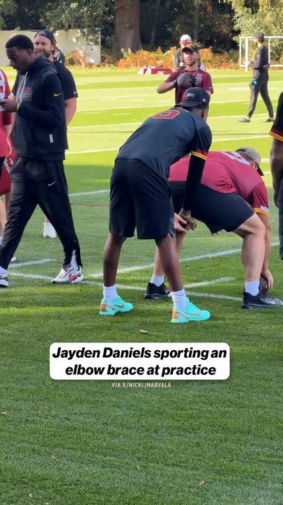 Jayden Daniels sporting an elbow brace at practice