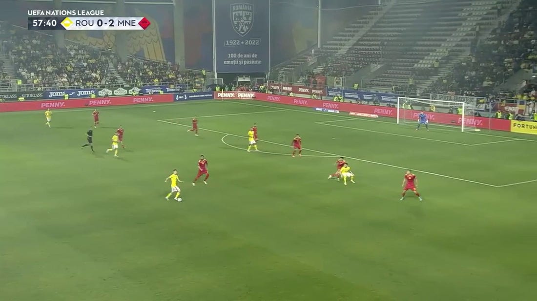 Stefan Mugosa heads it in to give Montenegro a 2-0 lead over Romania