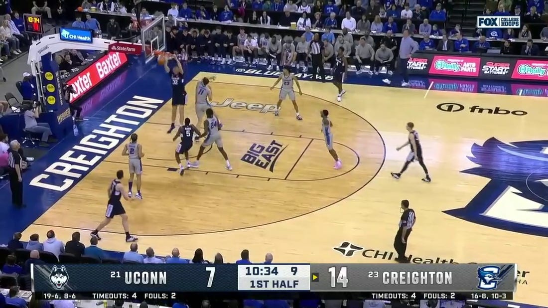 UConn's Donovan Clingan gets up for the alley-oop on the lob from Hassan Diarra