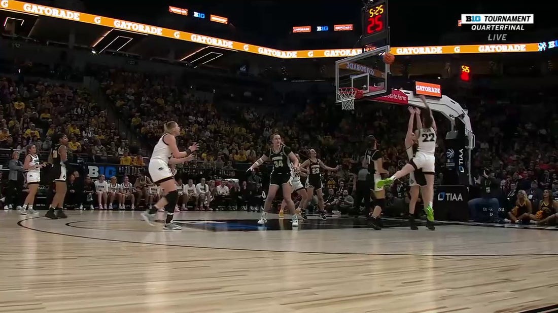 Iowa's Caitlin Clark banks a tough shot and draws the foul against Purdue