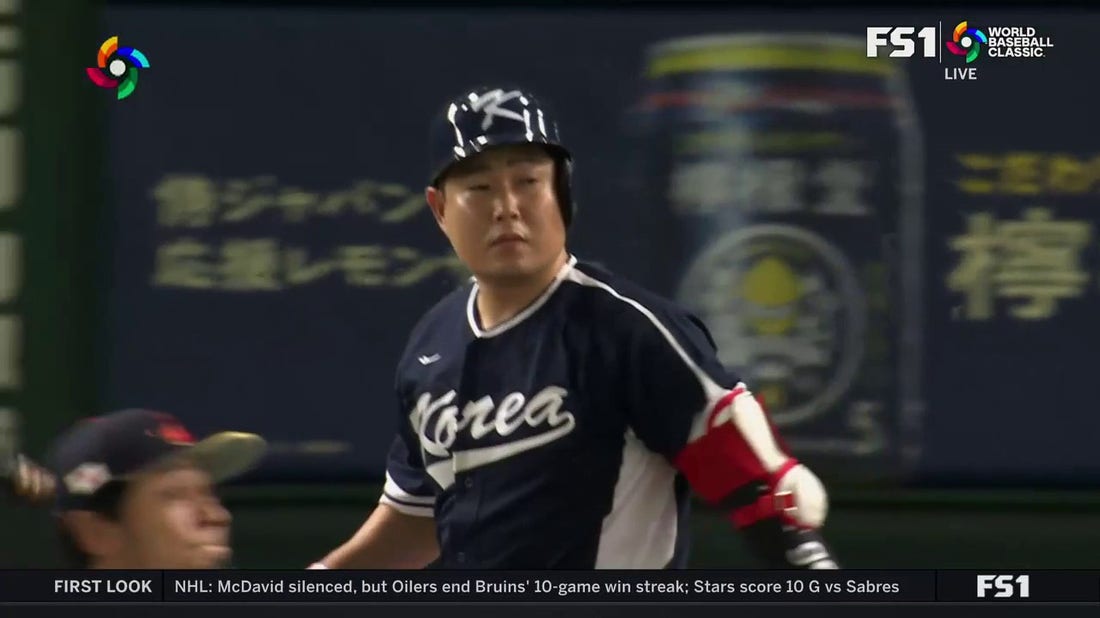 Euiji Yang crushes a home run deep to left field to give Korea a 2-0 lead over Japan