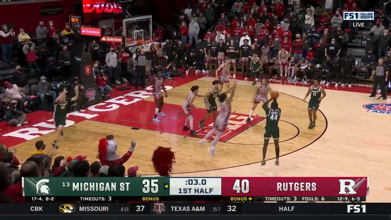 Gabe Brown hits a three-pointer at the buzzer to bring Michigan State within two point of Rutgers at the half