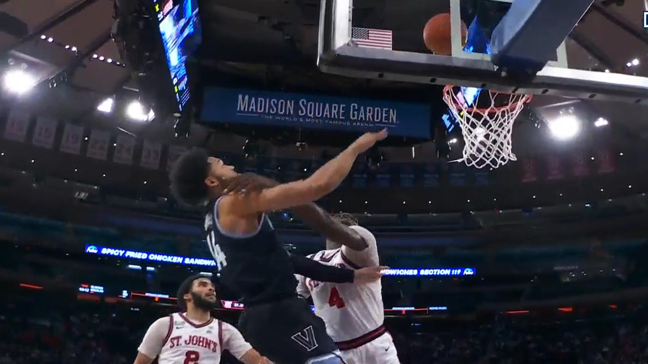 Villanova's Eric Dixon hits the floor to secure the loose ball and dishes to Caleb Daniels for the and-one