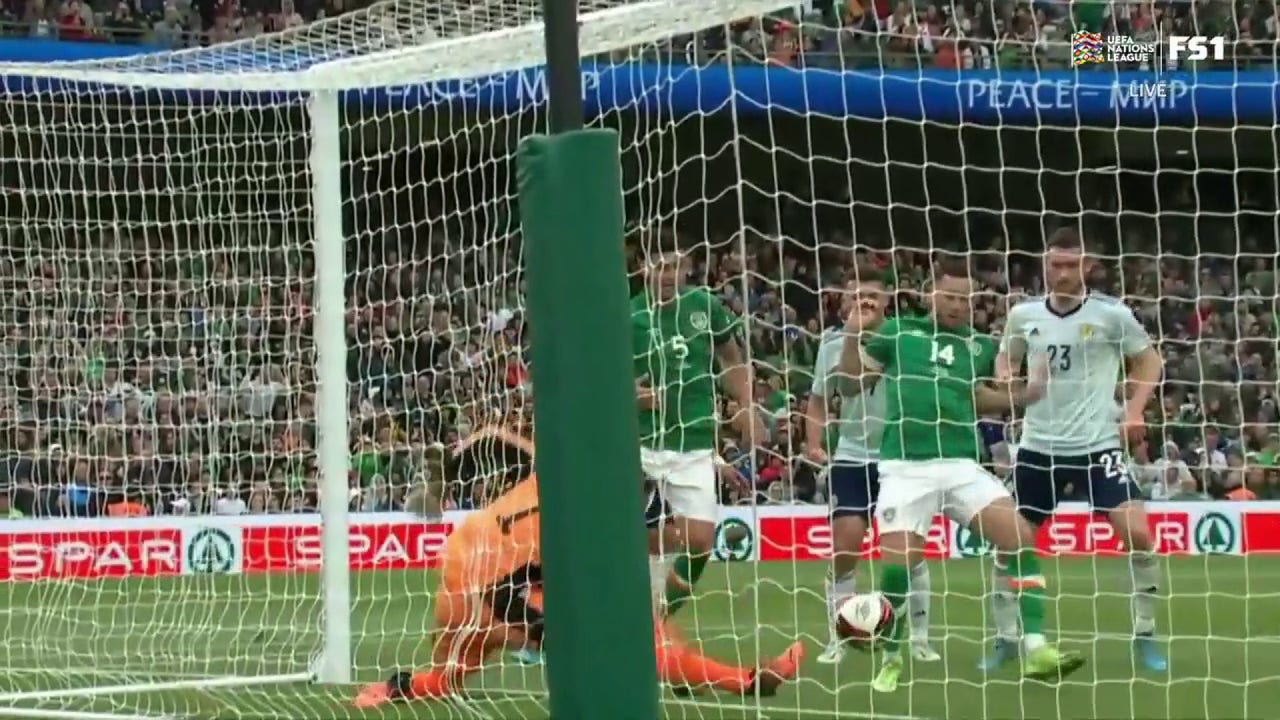 Alan Browne uses his body to sneak a goal past the Scotland keeper, 1-0