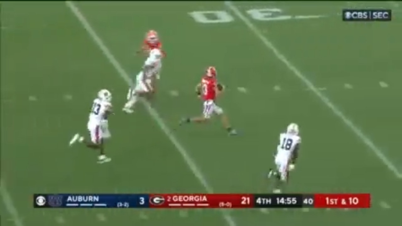 Georgia's Stetson Bennett speeds past defenders for a 64-yard rushing touchdown against Auburn