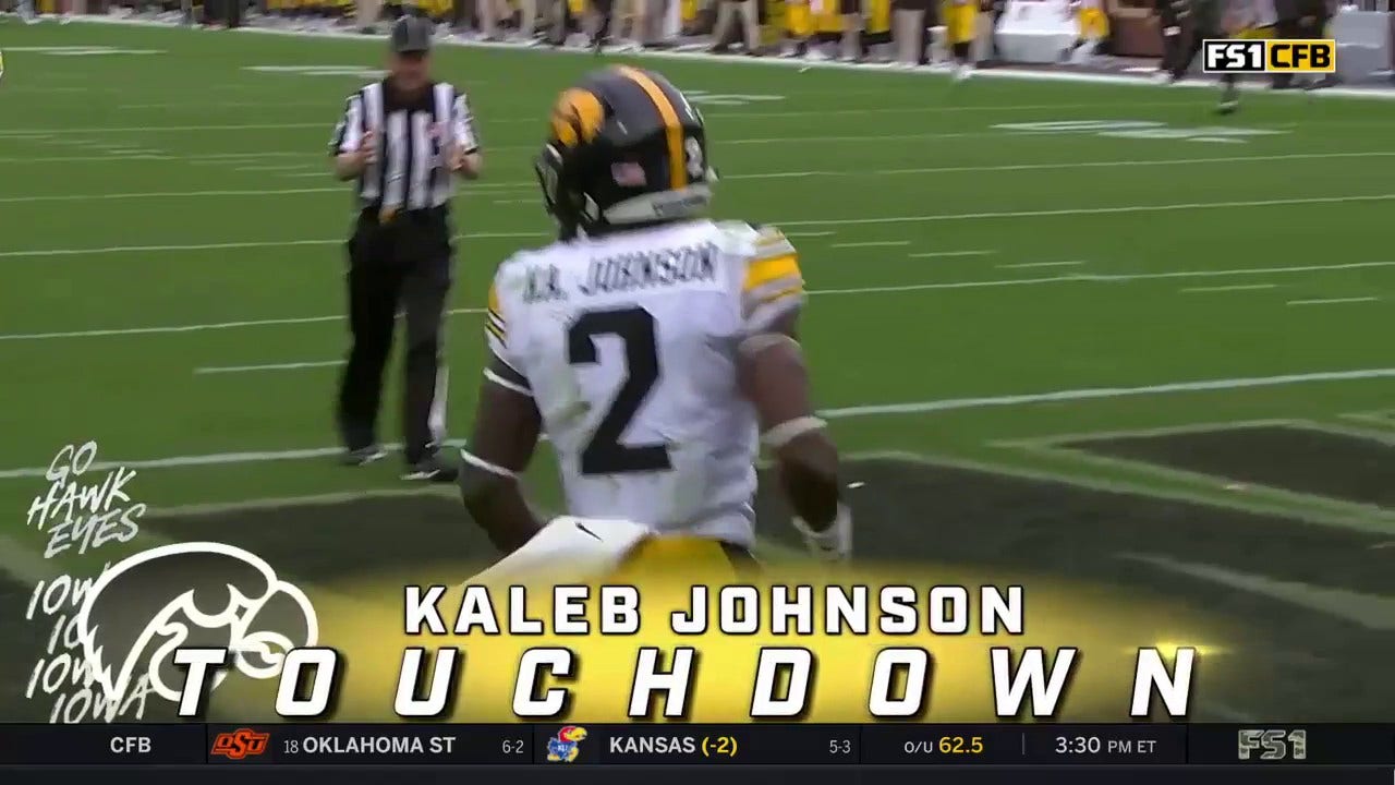 Iowa's Spencer Petras hands off to Kaleb Johnson for a 75-yard rushing touchdown extending their lead 24-3
