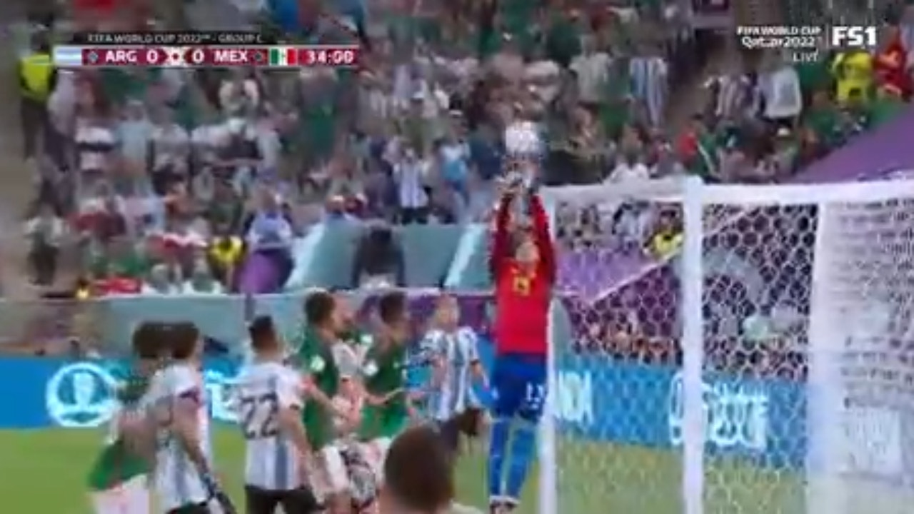 Argentina's Lionel Messi on the brink of his first goal of the match, punched away by Ochoa | 2022 FIFA World Cup
