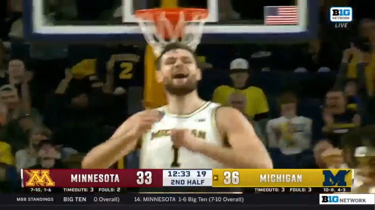Michigan's Hunter Dickinson finishes the tough and-1 to extend the Wolverines' lead
