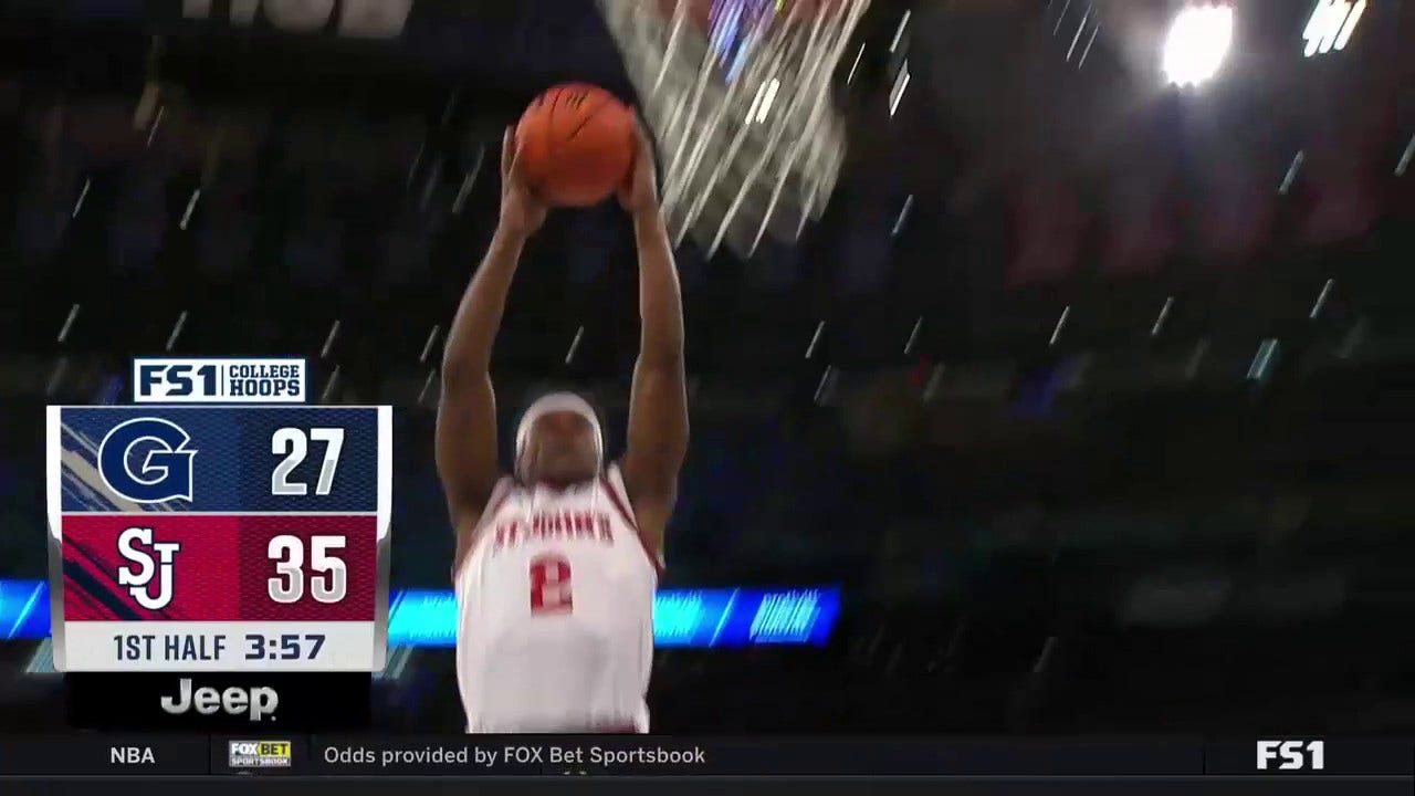 AJ Storr soars through the air with a huge two-handed jam for St. John's