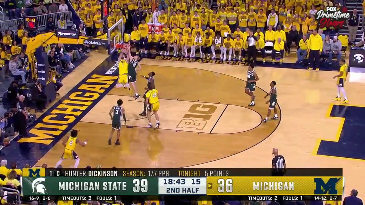 Michigan's Hunter Dickinson delivers a two-handed jam against Michigan State