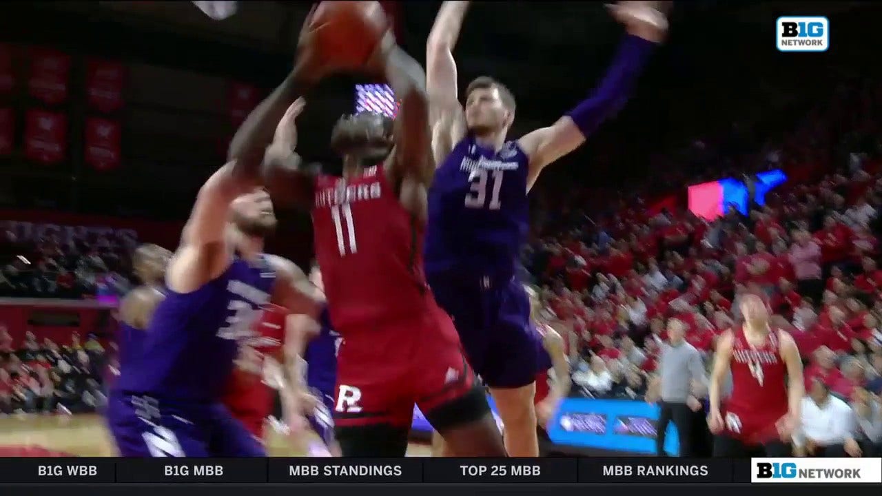 Rutgers' Clifford Omoruyi fights for the rebound and hits the shot at the buzzer heading into half