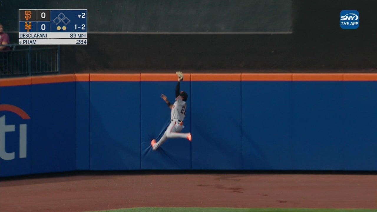 Giants' Luis Matos makes a leaping catch in centerfield to rob Mets' Tommy Pham of an extra base hit