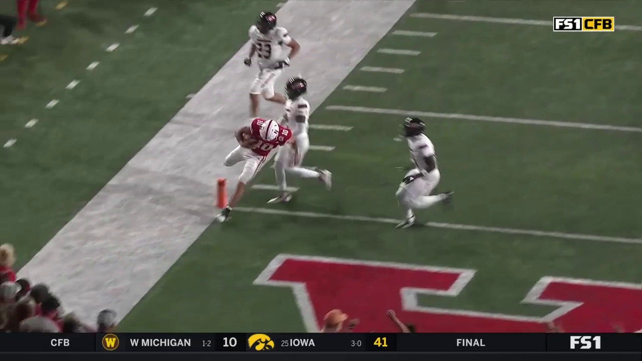 Heinrich Haarberg runs in a 20-yard touchdown, extending Nebraska's lead over Northern Illinois