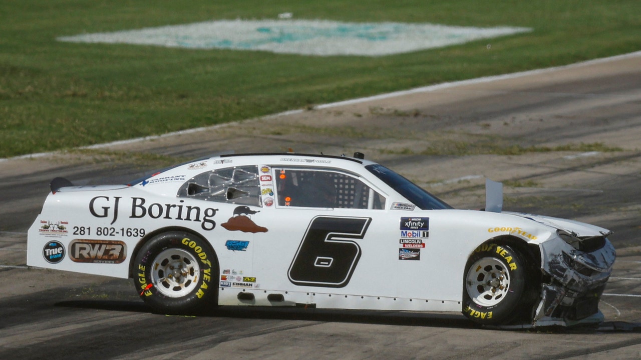 Brennan Poole slides through the grass and slams hard into the pit wall during the Andy's Frozen Custard 300