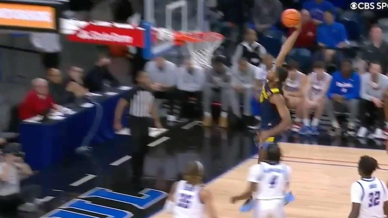 Justin Lewis drives to the rim and throws down a one-hand jam as Marquette cuts into DePaul's lead