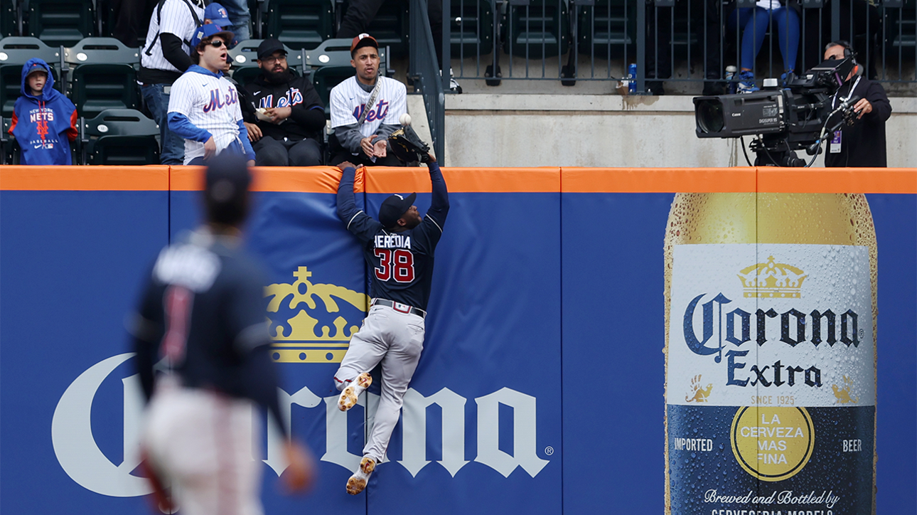 Guillermo Heredia scales the wall to rob Jeff McNeil of a home run
