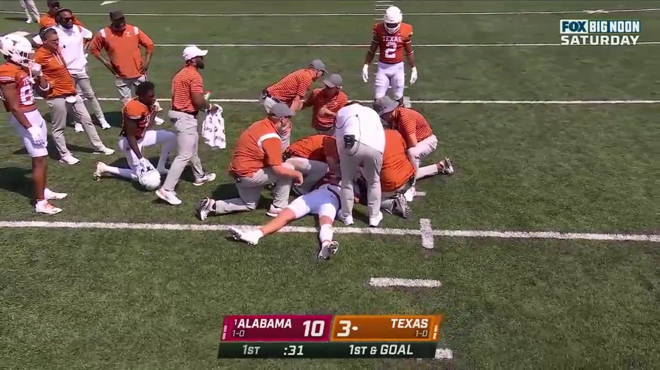 Texas QB Quinn Ewers goes down awkwardly on his shoulder and is helped to the locker room