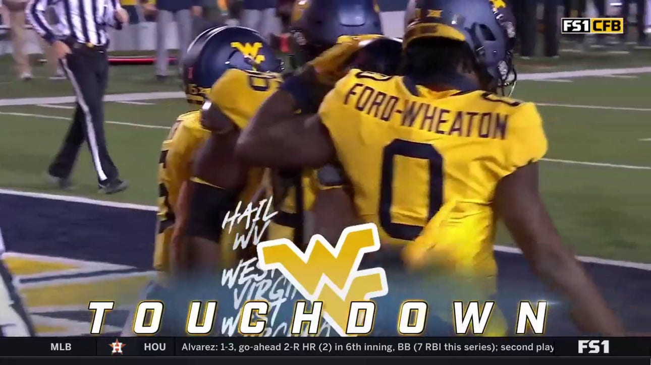 Tony Mathis punches in a seven-yard touchdown rush to get West Virginia on the board