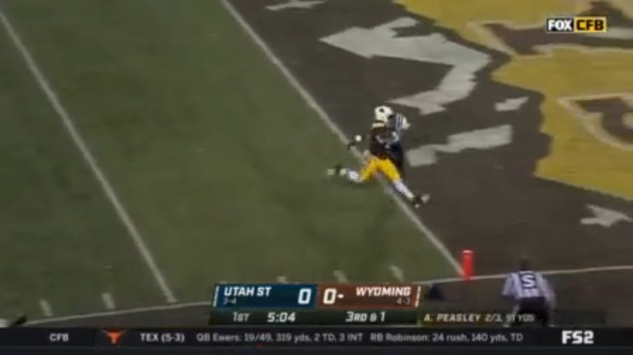 Wyoming's Titus Swen breaks a 30-yard touchdown rush to put the Cowboys on the board
