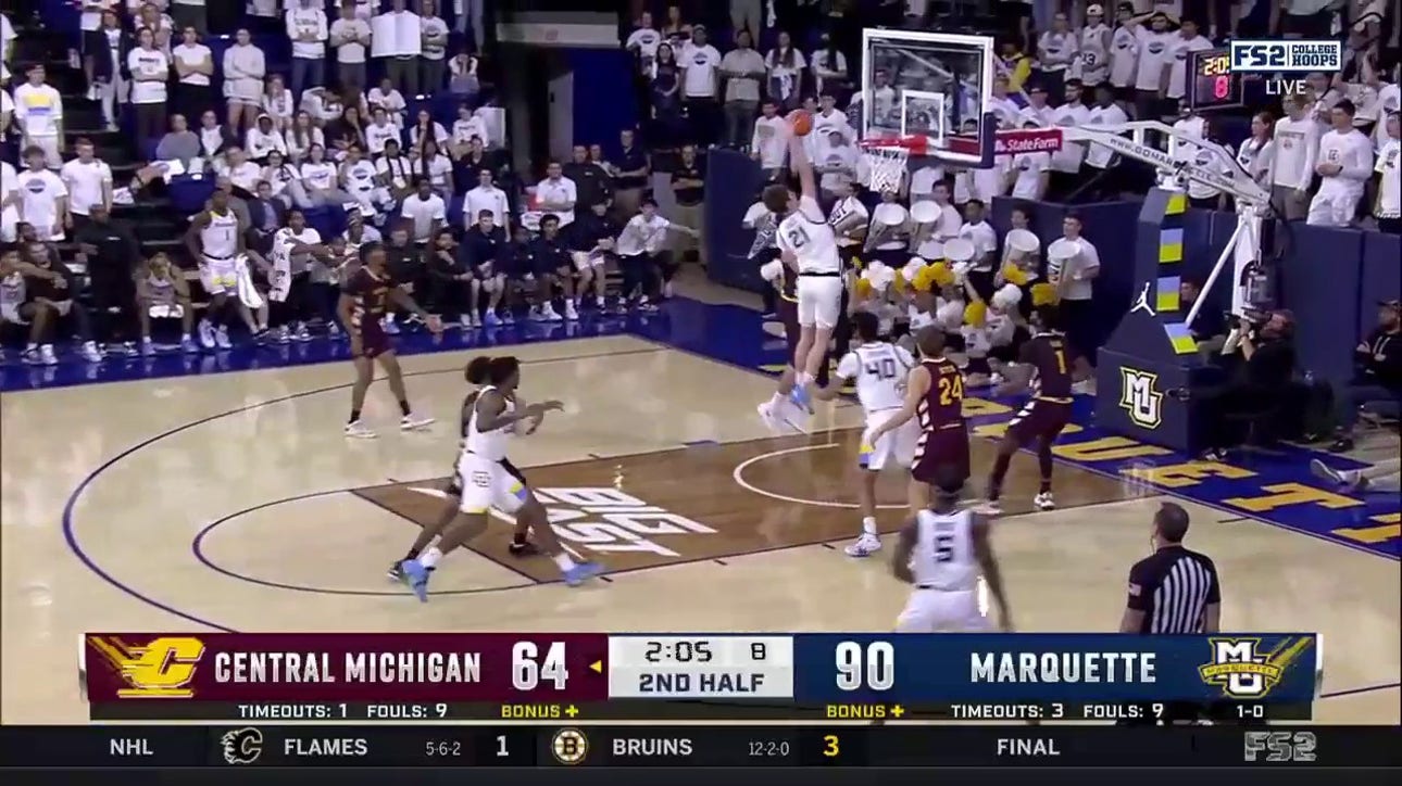 Marquette's Ben Gold throws down a one-handed poster dunk helping to extend their lead