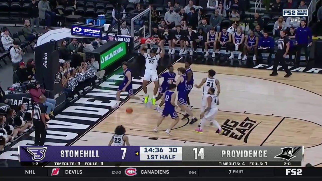 Providence's Bryce Hopkins throws down a two-handed slam assisted by Jared Bynum.
