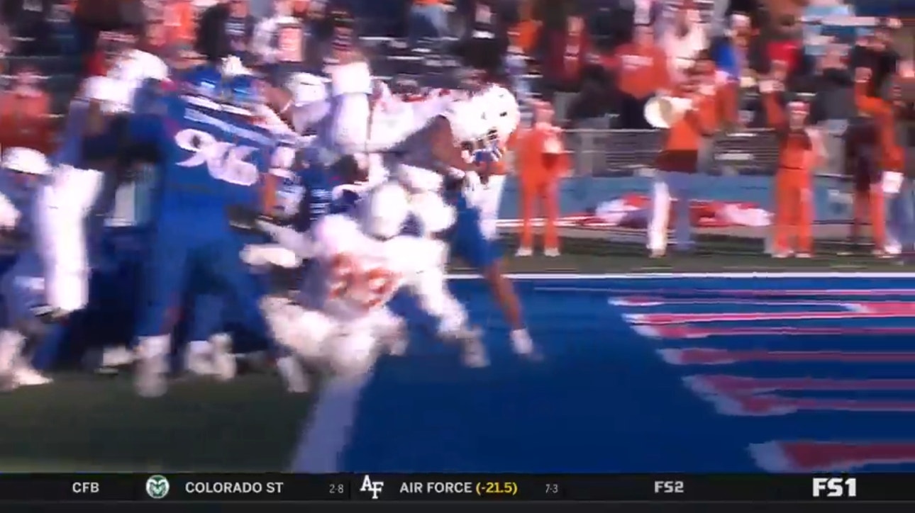 Bijan Robinson leaps into the endzone for his third touchdown of the first half as Texas leads big