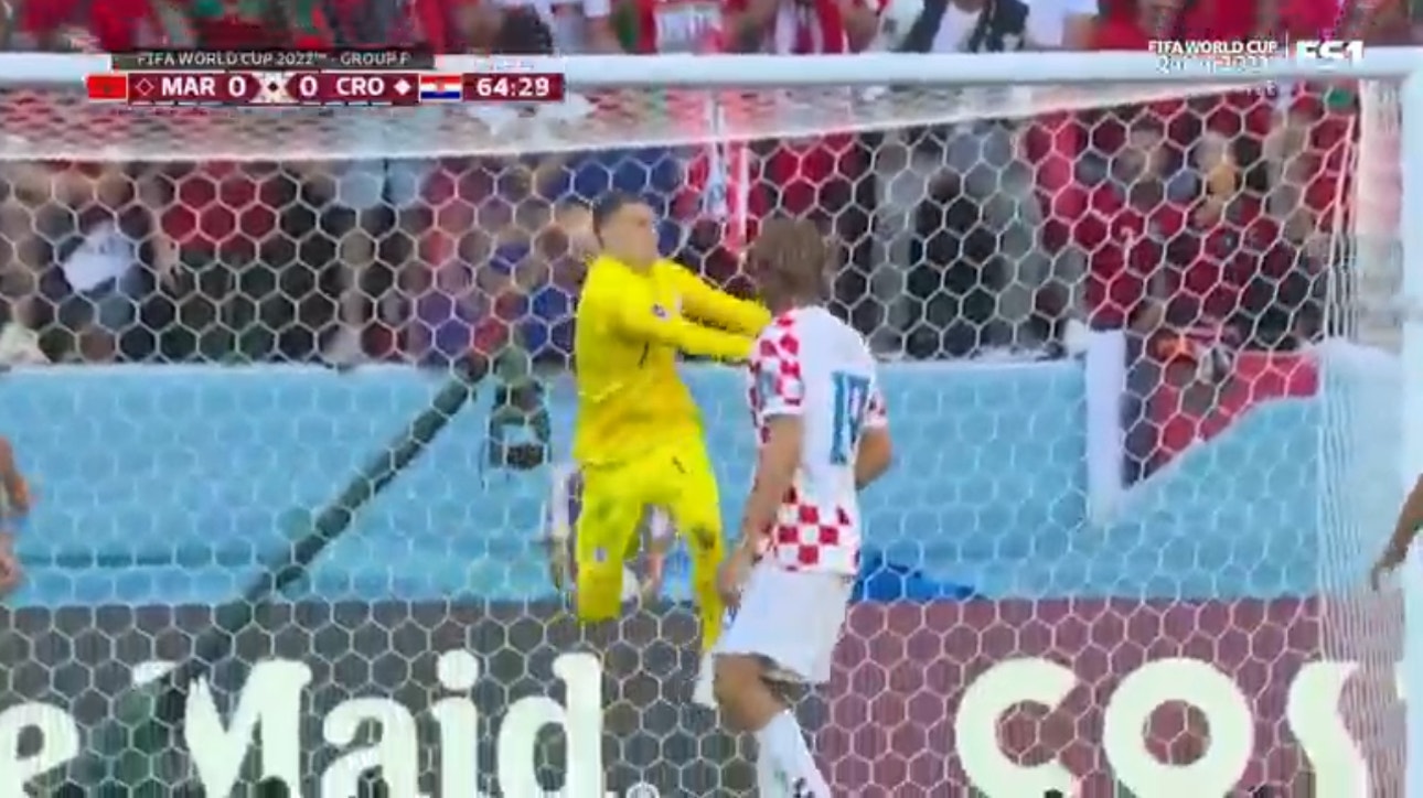 Croatia's Dominik Livaković bats away a wicked strike from outside the box by Morocco's Achraf Hakimi