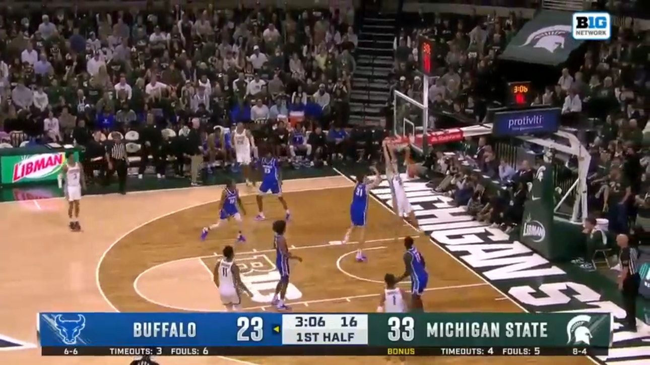Michigan State Spartan's Carson Cooper throws down an alley-oop slam to extend lead over Buffalo