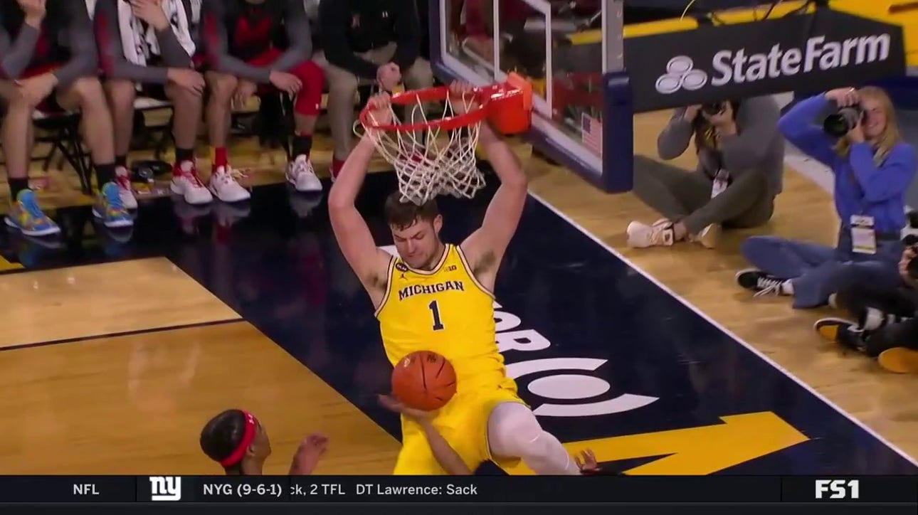 Michigan's Hunter Dickinson throws down a two-hand slam to increase the lead