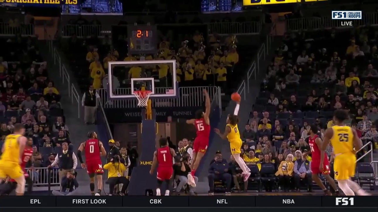 Michigan's Dug McDaniel runs the court and hits the acrobatic layup to end the half