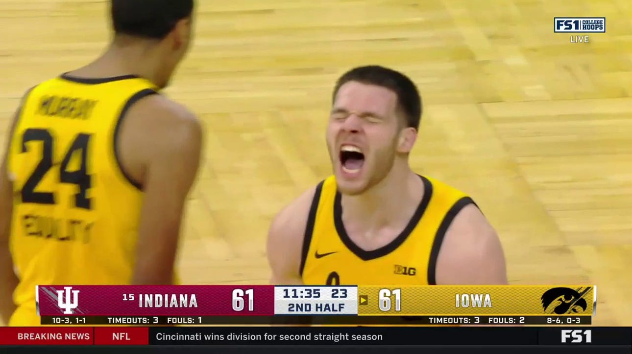 Flilip Rebraca hits the shot inside and-1 to give Iowa the lead over Indiana