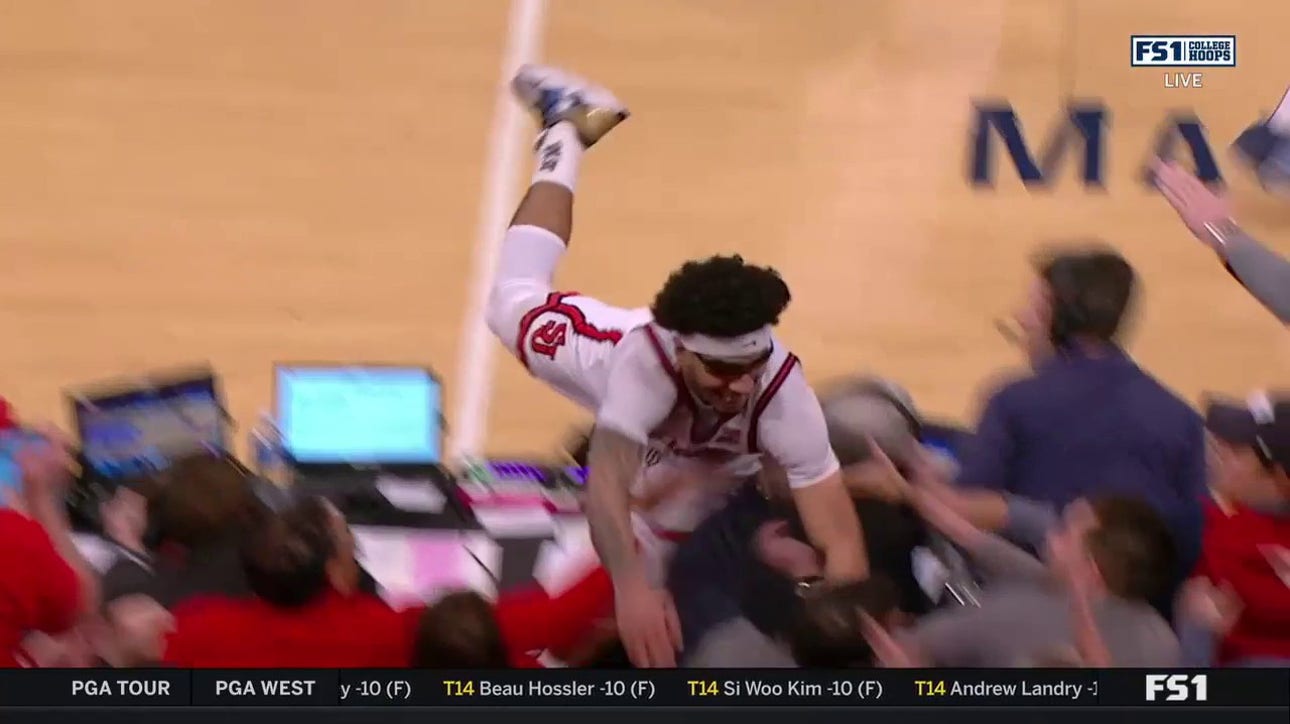 St. John's Andre Curbelo dives into the crowd for a loose ball in matchup with Villanova