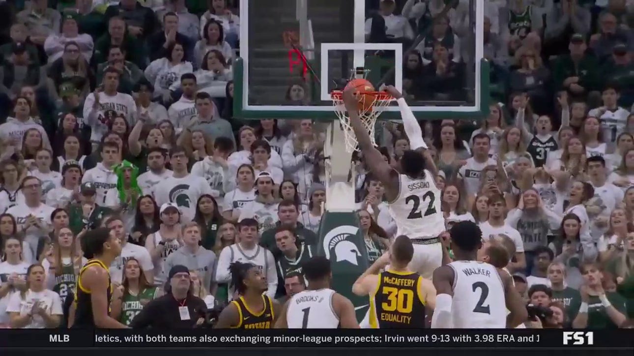 Michigan State's Mady Sissoko rattles the rim with a two-handed jam to even the score against Iowa 