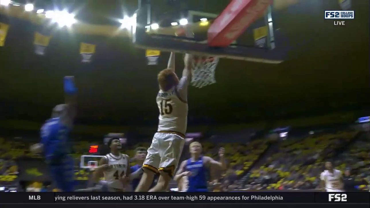 Wyoming's Nate Barnhart drives baseline for a monster two-hand dunk against Air Force