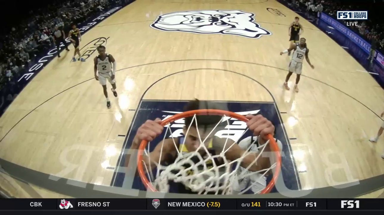 Oso Ighodaro slams down a two-handed jam for Marquette to extend their lead over Butler