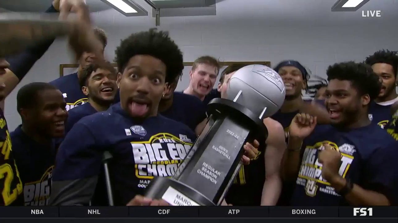 Marquette men's hoops team celebrates in the locker room after clinching their first outright Big East title in school history