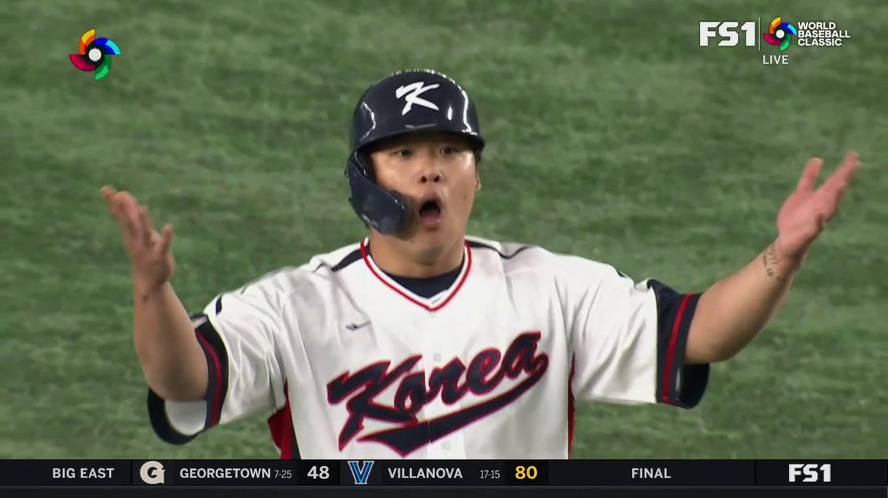 Korea's Baekho Kang celebrates after a double and steps off the base, resulting in a tag-out against Australia