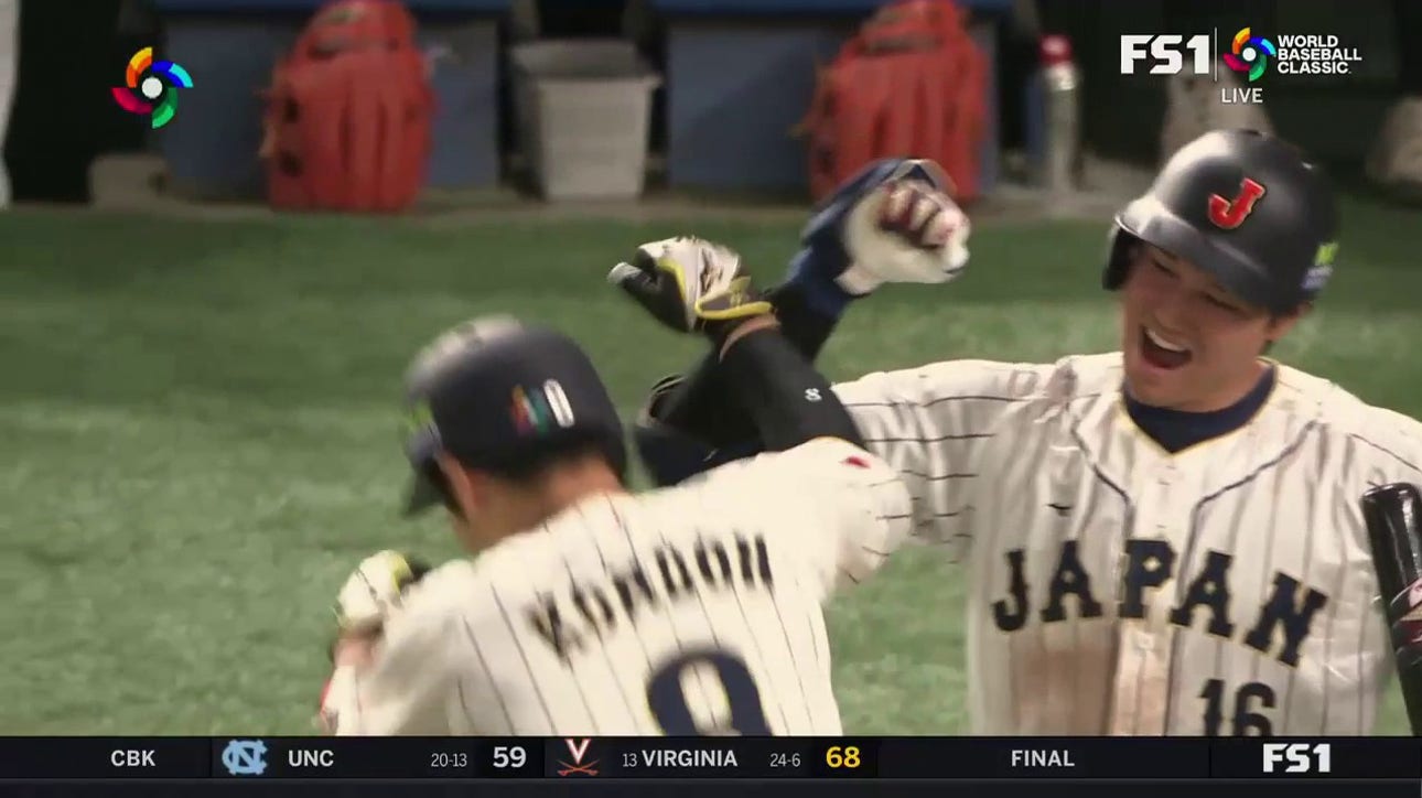 Japan's Kensuke Kondoh belts a home run to give Japan a 5-3 lead over Korea