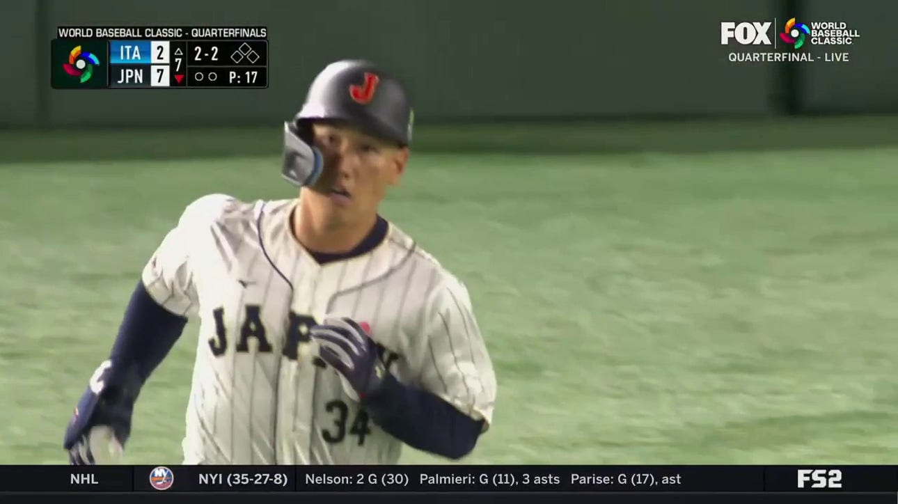 Masataka Yoshida crushes a home run to right field that extends Japan's lead over Italy to 8-2