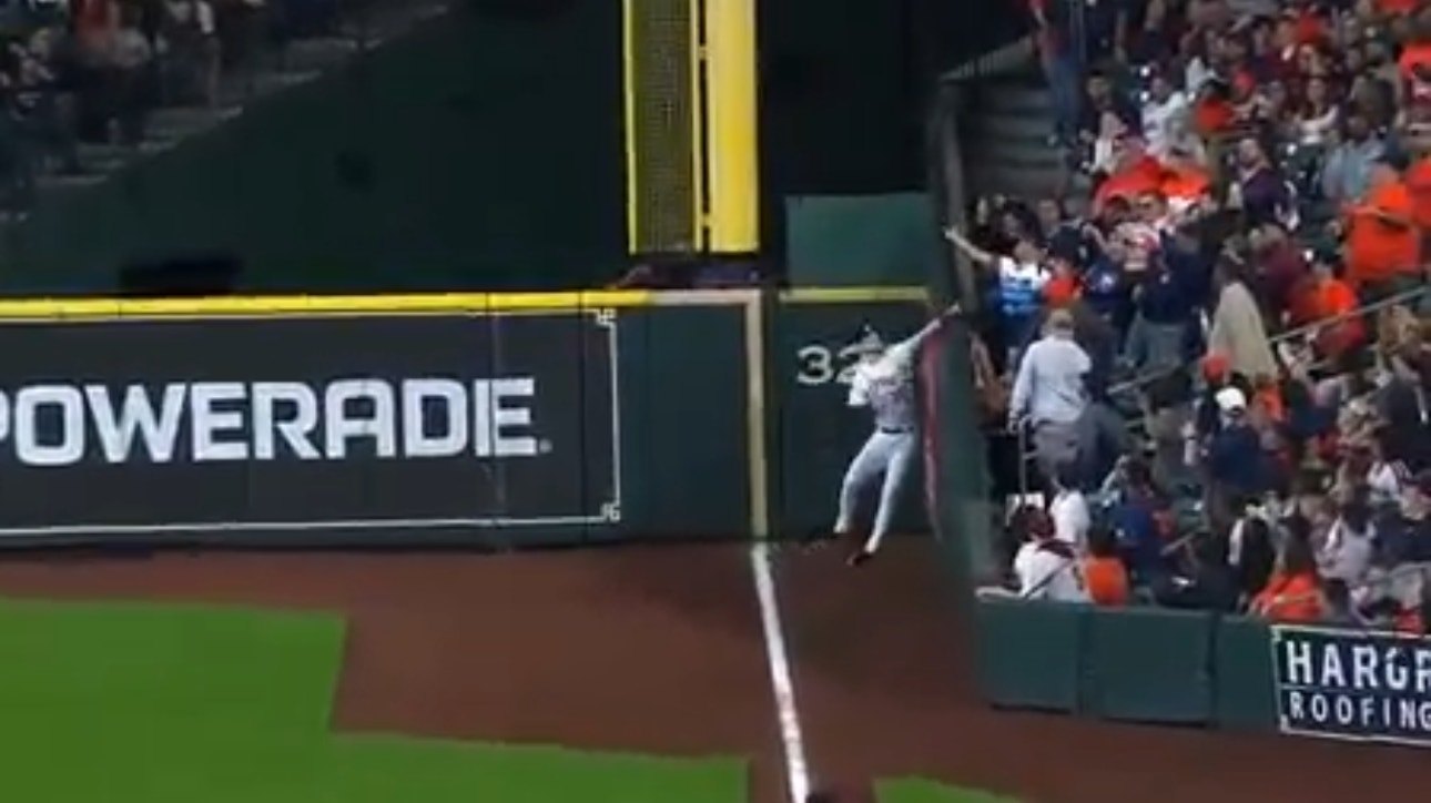 Astros' Kyle Tucker reaches over the wall to make an impressive grab in foul territory