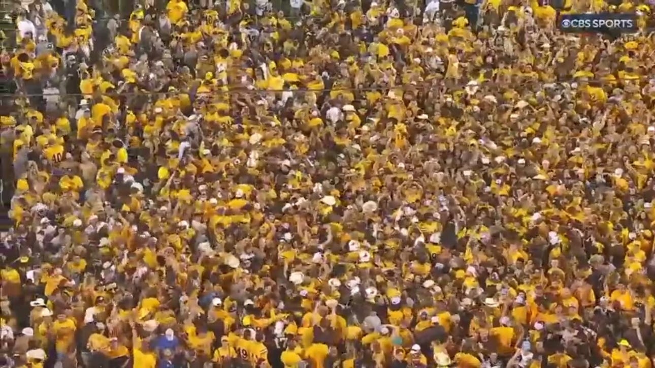 Fans rush the field after Sam Scott's two-point conversation seals Wyoming's upset victory over Texas Tech